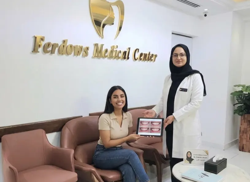 Dr. Zohreh Ahrari and patient in the back ground of Ferdows Medical center